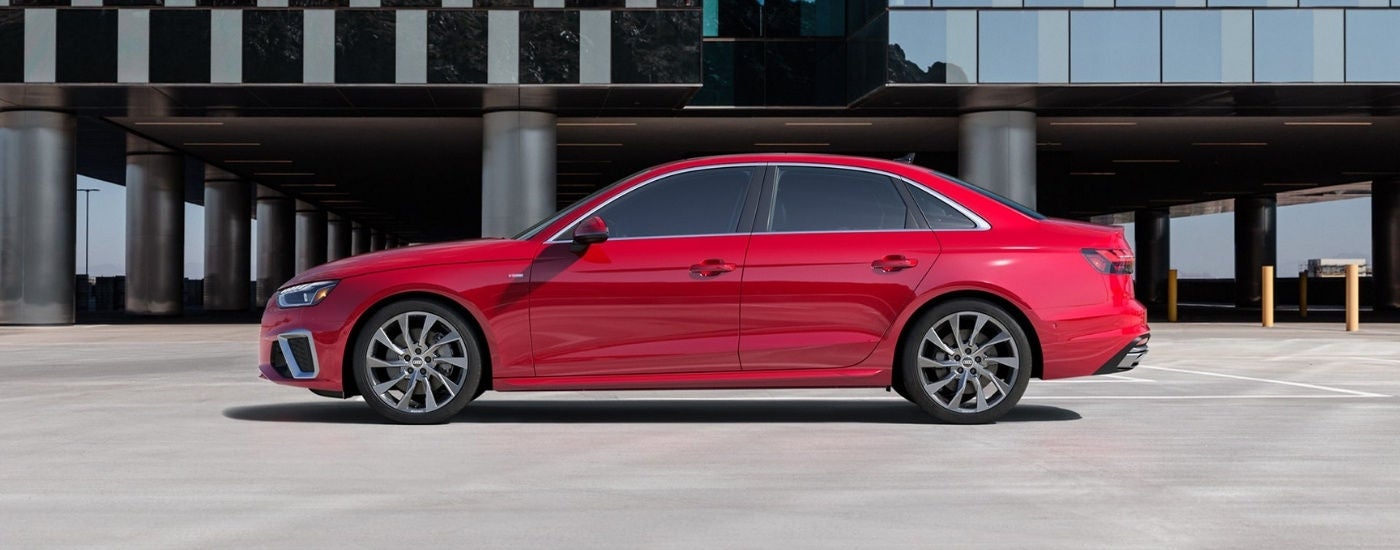 A red  2020 Audi A4 in front of a a building.